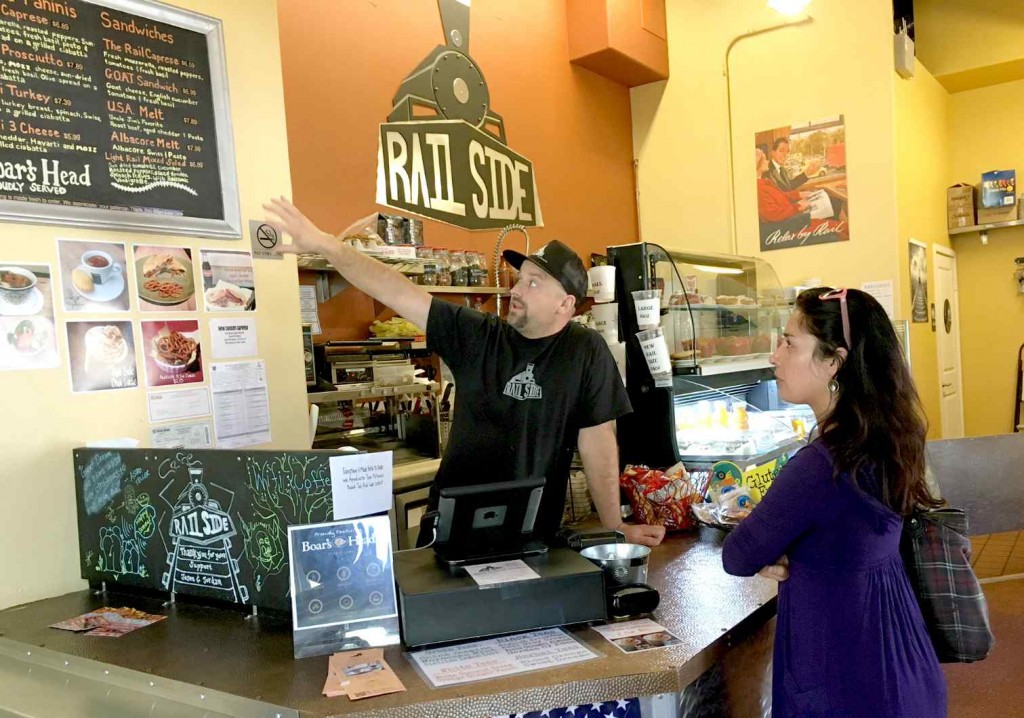 Railside Cafe owner Jordan Nachbaur takes an order from Glendora resident Anisa Hans. The Railside Cafe is part of the Grove Station mixed-used development in San Dimas, Calif., which was built in anticipation of the Gold Line station. Sept. 9, 2016. (Neil Nisperos/Inland Valley Daily Bulletin-SCNG) 