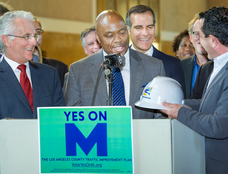 Paul Krekorian, Los Angeles councilmember, and Los Angeles Mayor Eric Garcetti watching Habib Balian, right, Foothill Gold Line Construction Authority CEO giving Phil Washington. CEO of Los Angeles County Metropolitan Transportation Authority a Hard Hat Safety Helmet, for work that needs to be accomplished now the Yes On M that voters passed. Los Angeles Metro press conferences was held at  Union Station Wednesday, November 9, 2016 in Los Angeles.  (Photo by Walt Mancini/Pasadena Star-News/SCNG)